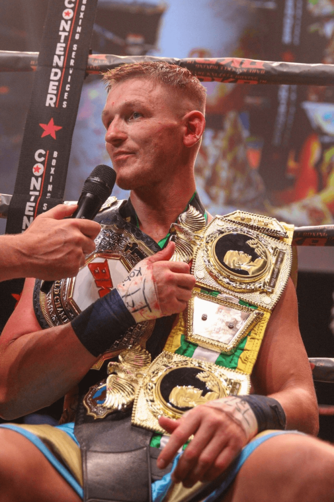 Barrie Jones photographed with his belts while doing an interview.